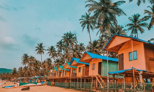 	
                                        A vibrant row of beachfront houses, each painted in different colors, creating a picturesque scene.
